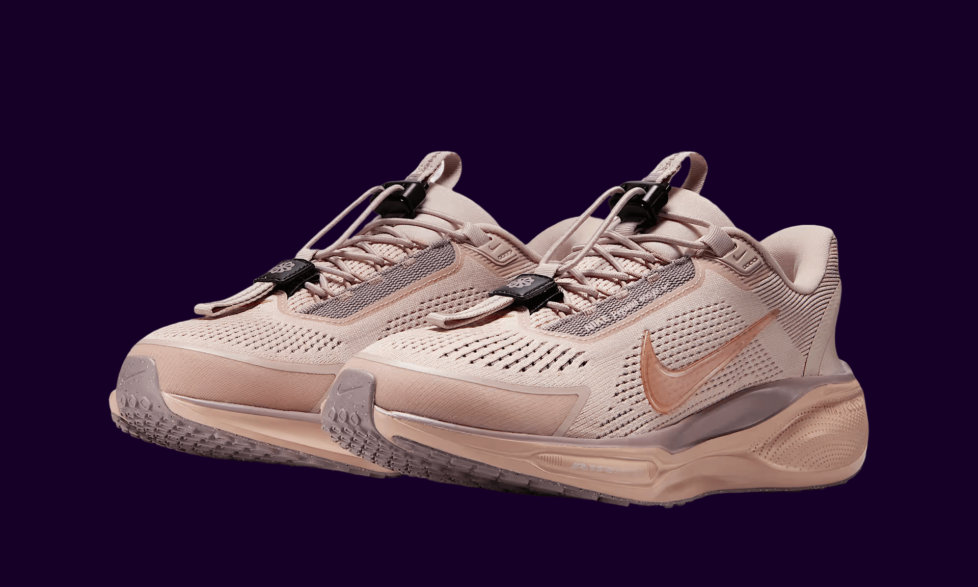 Pink sneakers on dark purple background