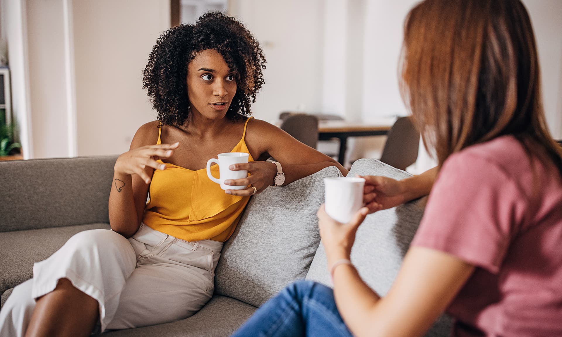 Two women talking on a couch