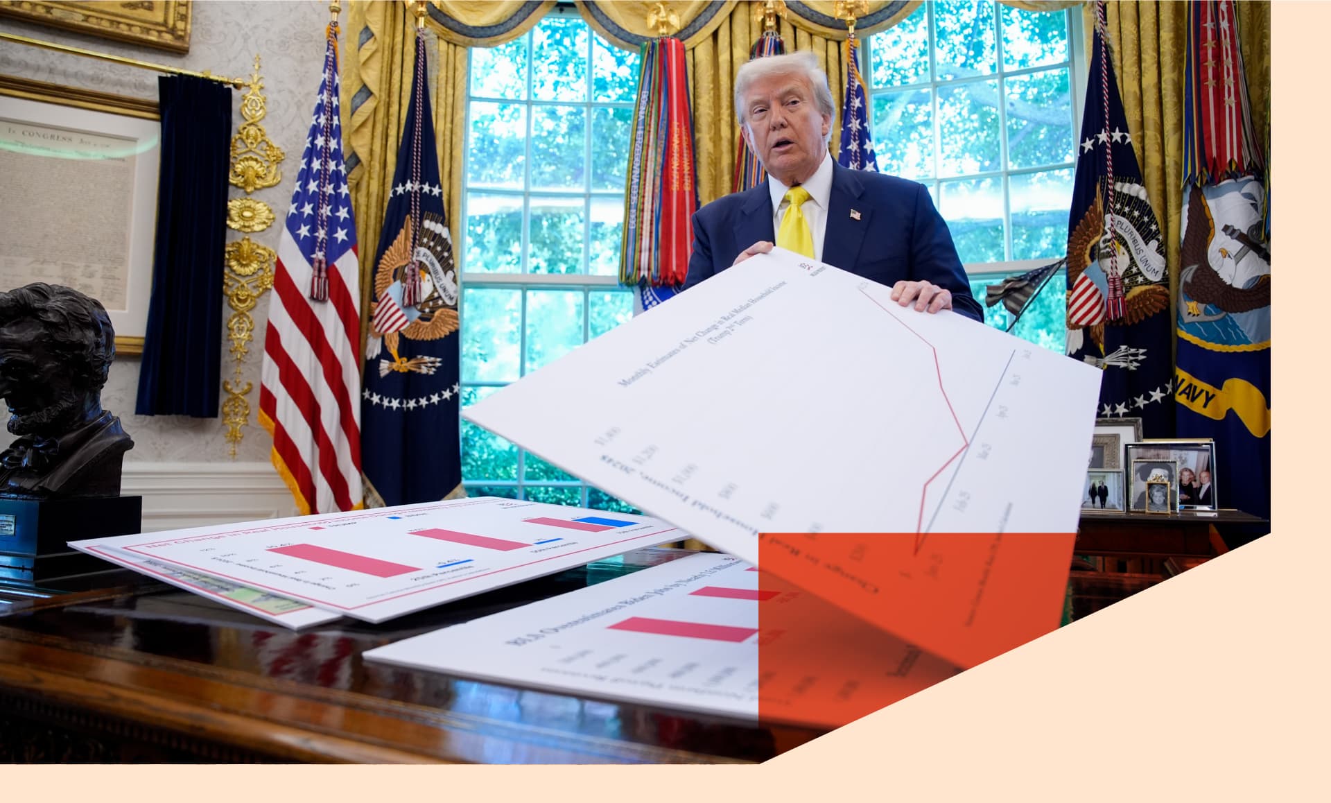 US President Donald Trump holds a chart on household income in the Oval Office of the White House
