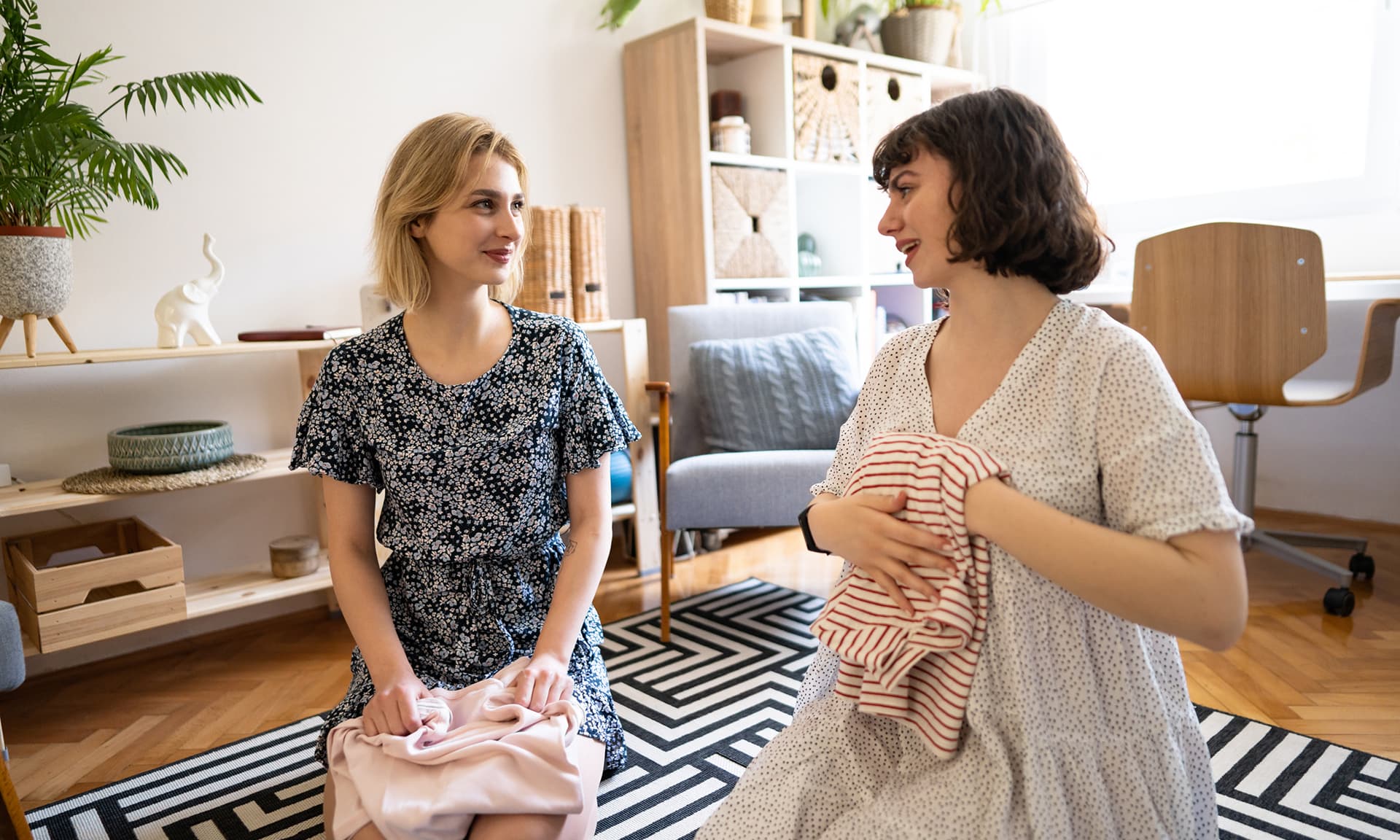 Two women folding clothes