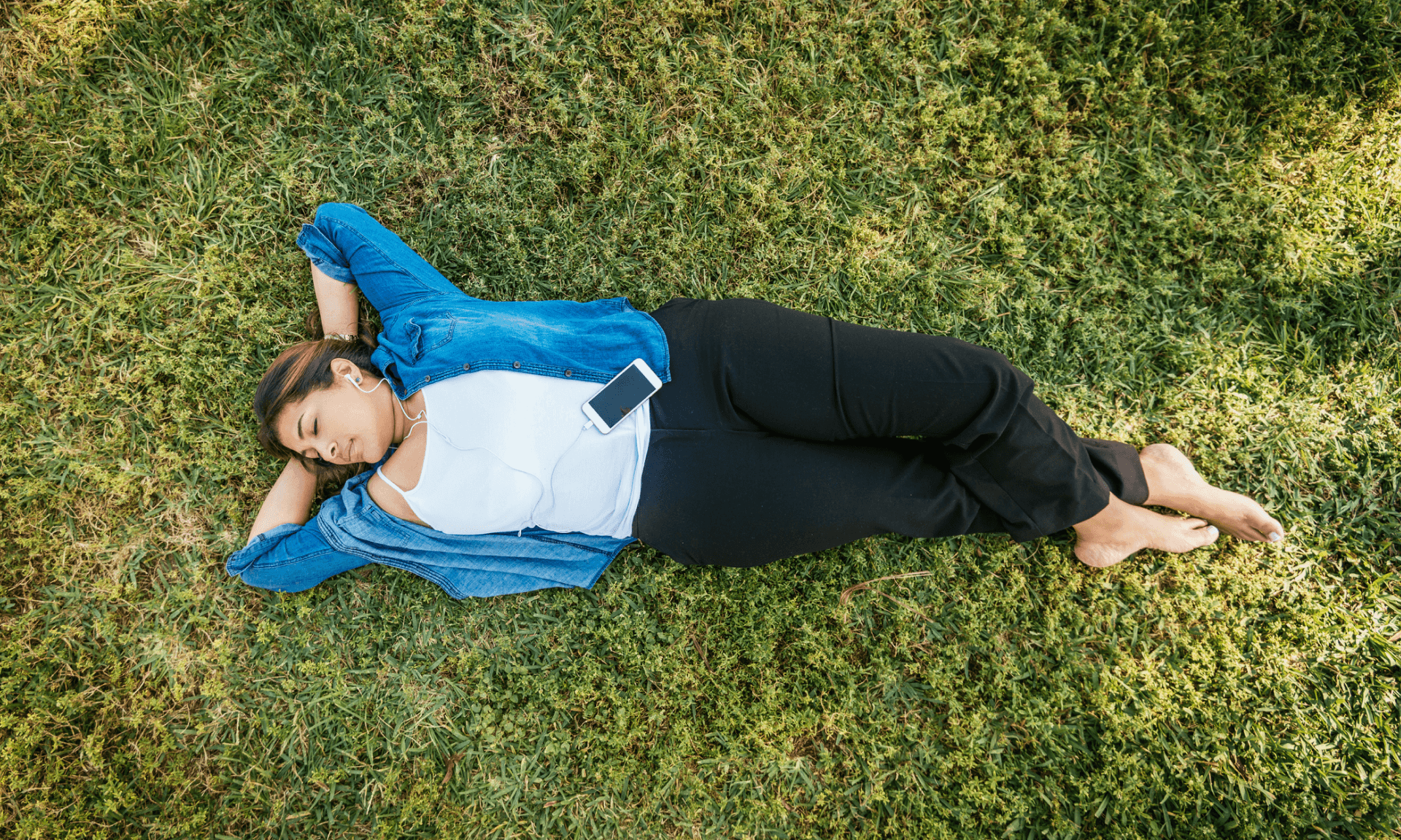 A woman laying in the grass